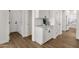 Bright laundry room with white cabinets, a front-load washer, and light hardwood floors at 389 W Fairway Pl, Chandler, AZ 85225