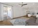 Bright open-concept living area boasts sliding glass doors, wood floors, and flows into a white kitchen at 389 W Fairway Pl, Chandler, AZ 85225