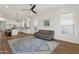 Inviting living room with wood floors, neutral tones, and seamlessly connected to the modern white kitchen at 389 W Fairway Pl, Chandler, AZ 85225