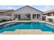 A refreshing backyard pool set against the home's exterior offers a serene escape from the desert heat at 389 W Fairway Pl, Chandler, AZ 85225
