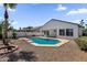 The backyard showcases a sparkling pool with gravel landscaping, providing an oasis for relaxation and enjoyment at 389 W Fairway Pl, Chandler, AZ 85225