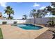 Backyard view of outdoor swimming pool, palm trees, and a brick wall at 389 W Fairway Pl, Chandler, AZ 85225