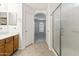 Bright bathroom features walk-in shower, tile floors and vanity with cabinets at 43813 W Rio Lobo Dr, Maricopa, AZ 85138