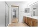 Bathroom featuring a walk-in shower, vanity with storage and bright lighting at 43813 W Rio Lobo Dr, Maricopa, AZ 85138