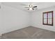 Comfortable bedroom with large window with plantation shutters at 43813 W Rio Lobo Dr, Maricopa, AZ 85138