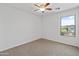 Neutral bedroom featuring a ceiling fan and ample natural light at 43813 W Rio Lobo Dr, Maricopa, AZ 85138