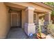 Inviting covered front porch with security door, potted cactus and views of desert landscaping at 43813 W Rio Lobo Dr, Maricopa, AZ 85138