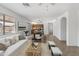Cozy and open living room with a view of the kitchen and dining area, perfect for entertaining at 43813 W Rio Lobo Dr, Maricopa, AZ 85138