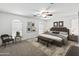 Staged main bedroom with neutral colors, ceiling fan, and decorative rug at 43813 W Rio Lobo Dr, Maricopa, AZ 85138
