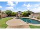 Backyard pool and patio are perfect for outdoor entertaining at 43813 W Rio Lobo Dr, Maricopa, AZ 85138