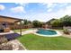 Backyard has a private pool surrounded by lush landscaping at 43813 W Rio Lobo Dr, Maricopa, AZ 85138