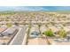 Expansive aerial view of a suburban neighborhood with mature trees, community amenities, and well-maintained homes at 46068 W Guilder Ave, Maricopa, AZ 85139