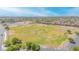 Expansive aerial view of neighborhood with community park, ball fields and green spaces at 46068 W Guilder Ave, Maricopa, AZ 85139