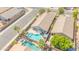 Aerial view of a private backyard oasis with a swimming pool, spa, covered patio, and desert landscaping at 46068 W Guilder Ave, Maricopa, AZ 85139