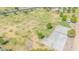 Aerial shot capturing a community park with basketball courts, lush green lawns, mature trees, and recreational facilities at 46068 W Guilder Ave, Maricopa, AZ 85139