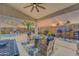 Relaxing covered patio with comfortable seating, perfect for outdoor entertainment and overlooking the pool at 46068 W Guilder Ave, Maricopa, AZ 85139