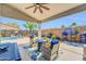 Inviting covered patio with stylish seating and a view of the pool, ideal for outdoor gatherings at 46068 W Guilder Ave, Maricopa, AZ 85139