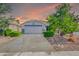 Charming single-story home with a well-manicured lawn, desert landscaping, and a two-car garage at 46068 W Guilder Ave, Maricopa, AZ 85139