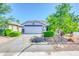 Charming single-story home featuring a well-manicured front yard with lush landscaping and a two-car garage at 46068 W Guilder Ave, Maricopa, AZ 85139