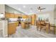 Inviting kitchen featuring stainless steel appliances, a center island, and a dining area at 46068 W Guilder Ave, Maricopa, AZ 85139