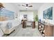 Bright home office with unique desk, beach-themed art, plantation shutters, and stylish decor at 46068 W Guilder Ave, Maricopa, AZ 85139