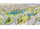Aerial view of a neighborhood lake featuring lush landscaping, walking paths, and tranquil water features at 46068 W Guilder Ave, Maricopa, AZ 85139