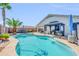 Sparkling pool with lounge area, a gazebo, palm trees, and a privacy wall at 46068 W Guilder Ave, Maricopa, AZ 85139