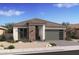 Beautiful single-story home featuring stone accents, a modern garage door, and professionally landscaped front yard at 490 E Aurora Dr, San Tan Valley, AZ 85140