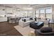 Open-concept living area with hardwood flooring, large windows, and seamlessly connected kitchen and dining spaces at 490 E Aurora Dr, San Tan Valley, AZ 85140