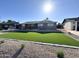 Landscaped front yard featuring artificial turf, decorative rock, and a charming brick house at 514 N 74Th St, Scottsdale, AZ 85257