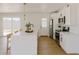 Modern kitchen with white cabinets, stainless steel appliances, and a spacious quartz countertop island at 514 N 74Th St, Scottsdale, AZ 85257