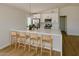 Contemporary kitchen with white cabinets, stainless steel appliances, and barstool seating at the island at 514 N 74Th St, Scottsdale, AZ 85257
