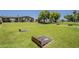 Large backyard with green lawn and wooden game structure at 5735 E Mcdowell Rd # 108, Mesa, AZ 85215