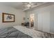 Comfortable bedroom featuring a ceiling fan, a desk, and an ensuite bathroom at 5735 E Mcdowell Rd # 108, Mesa, AZ 85215