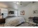 Bright bedroom with a ceiling fan, a TV, and a desk, offering comfort and functionality at 5735 E Mcdowell Rd # 108, Mesa, AZ 85215