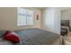 Well-lit bedroom featuring a cozy bed with a gray quilt and sliding door closet at 5735 E Mcdowell Rd # 108, Mesa, AZ 85215