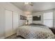 Bedroom featuring a ceiling fan, a TV, and an adjacent closet at 5735 E Mcdowell Rd # 108, Mesa, AZ 85215