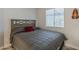 Cozy bedroom with a comfortable queen-sized bed and warm, natural light from the window at 5735 E Mcdowell Rd # 108, Mesa, AZ 85215