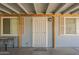 Covered carport features a decorative metal door and white framed windows at 5735 E Mcdowell Rd # 108, Mesa, AZ 85215