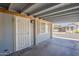 The covered carport features an ornate metal entry door and bright windows at 5735 E Mcdowell Rd # 108, Mesa, AZ 85215