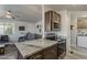 Kitchen with stainless appliances and granite counters seamlessly flows into the living room at 5735 E Mcdowell Rd # 108, Mesa, AZ 85215
