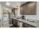 Modern kitchen with stainless steel appliances, granite countertops, and wooden cabinetry at 5735 E Mcdowell Rd # 108, Mesa, AZ 85215