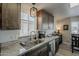 Kitchen sink featuring marble countertops, stainless appliances, and wooden cabinetry at 5735 E Mcdowell Rd # 108, Mesa, AZ 85215
