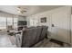 Cozy living room with gray reclining sofa and views from bright windows at 5735 E Mcdowell Rd # 108, Mesa, AZ 85215