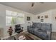Cozy living room with a comfortable gray sofa, a large window, and a rustic coffee table at 5735 E Mcdowell Rd # 108, Mesa, AZ 85215
