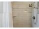 Bathroom shower featuring an adjustable shower head and decorative subway tile at 5735 E Mcdowell Rd # 108, Mesa, AZ 85215
