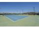 A blue tennis court with fences and lighting at 5735 E Mcdowell Rd # 108, Mesa, AZ 85215