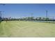 Well maintained green tennis court with net at 5735 E Mcdowell Rd # 108, Mesa, AZ 85215