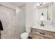 This renovated bathroom features marble tile, a custom vanity, and a modern shower at 5827 N 22Nd Dr, Phoenix, AZ 85015