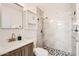 This renovated bathroom features marble tile, a custom vanity, and chrome plumbing fixtures at 5827 N 22Nd Dr, Phoenix, AZ 85015